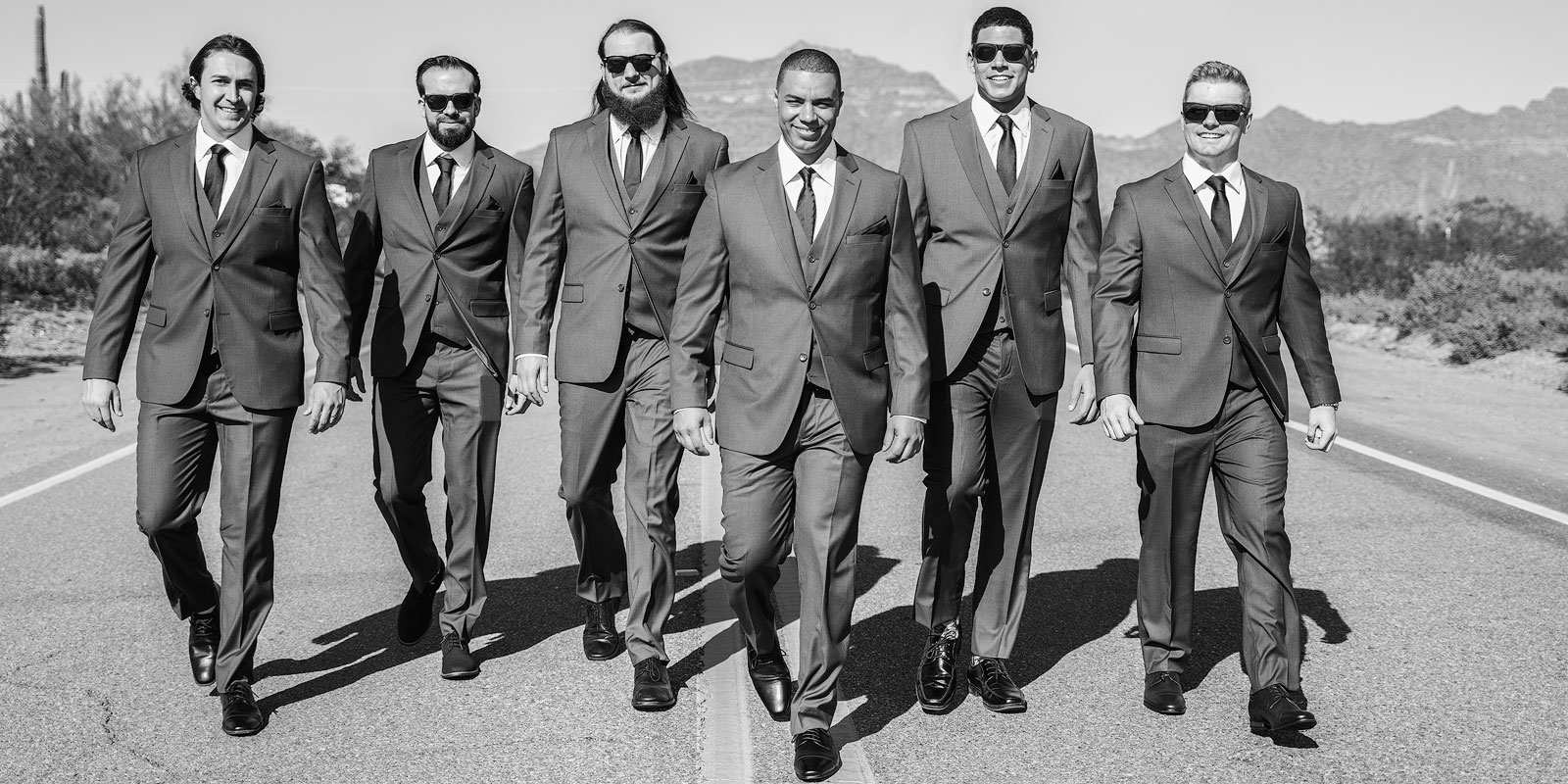 Justin and his groomsmen walking down the road.